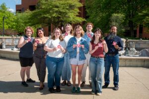 Group of students posing outside in the sun
