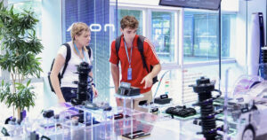 Two Ball State students explore automotive technology exhibits during an international study abroad experience.