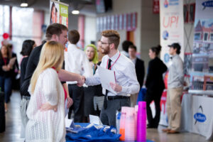 Students talk with an employer at the Cardinal Job Fair