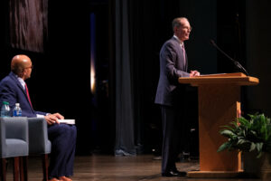 Ball State President Geoffrey S. Mearns speaks at the podium during Fall Opening Convocation as Provost Anand R. Marri looks on from the stage.