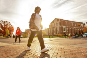 Students walk across campus at sunset