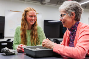 Student and faculty discuss geology in a classroom in the Cooper Science Building