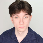 Headshot of a young man wearing a blue shirt.