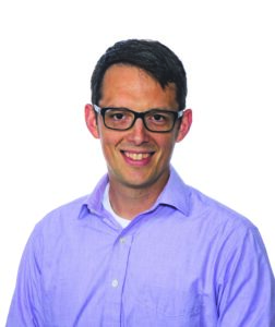 headshot of a man with glasses