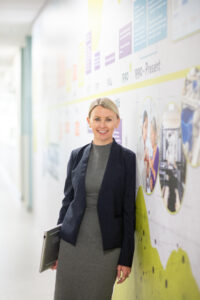 Woman standing in front of company timeline