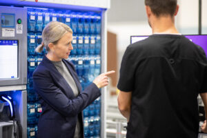 Woman CEO checking work of a pharmaceutical employee on a computer