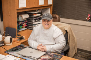 Michelle Rodgers, a Ball State Online doctorate student in Educational Administration, sits at her desk with her computer. She is currently an elementary school principal.