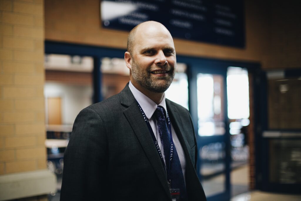Adam Bontreger, Ball State University alum and current EdD student, stands outside of his office at Tri-West Middle School.