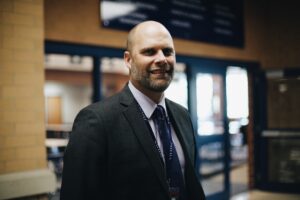 Adam Bontreger, Ball State University alum and current EdD student, stands outside of his office at Tri-West Middle School.