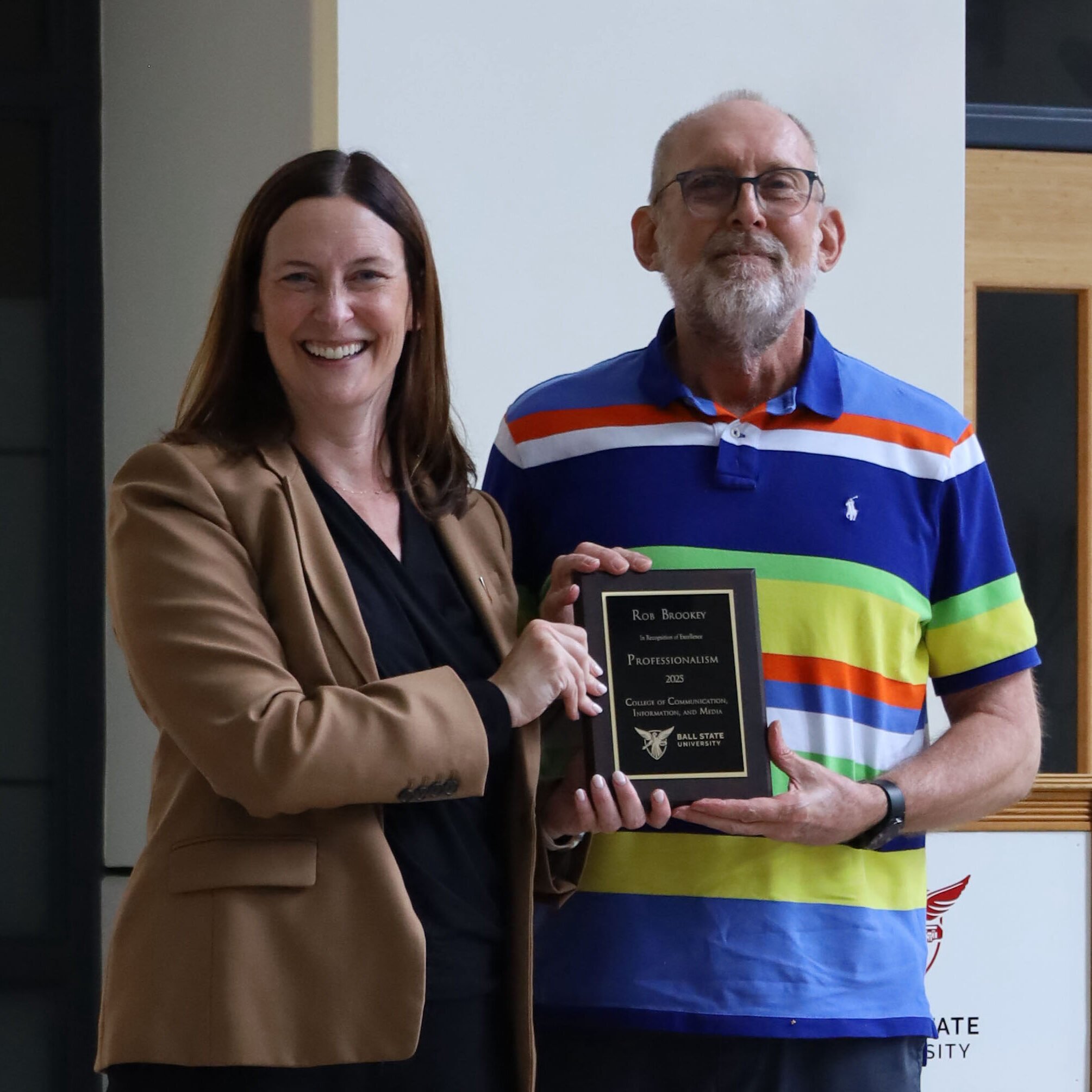 CCIM Dean Kristen McCauliff awards Rob Brookey with the Professionalism Award.