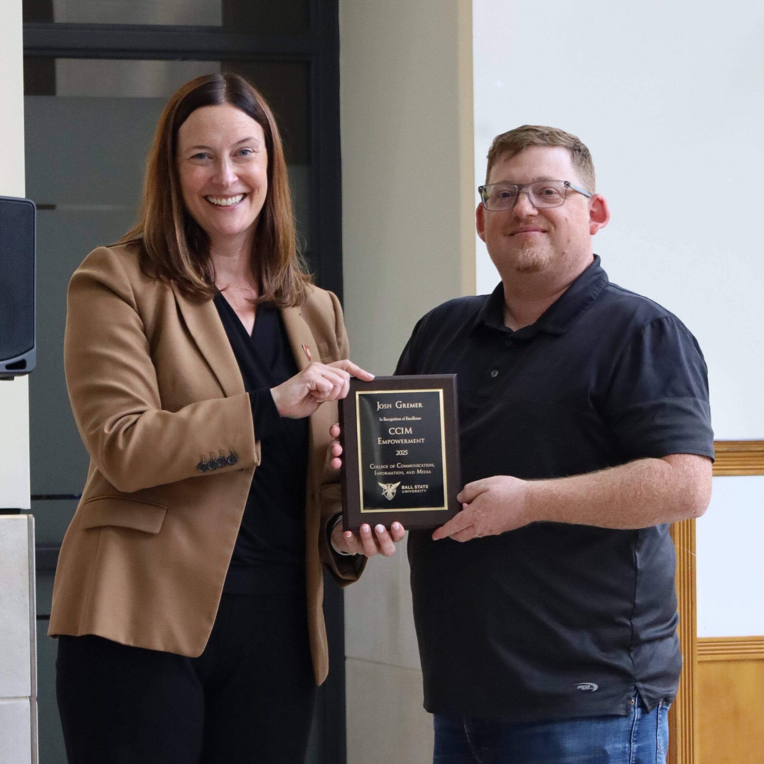 CCIM Dean kristen McCauliff awrds Josh Gremer the CCIM Empowerment Award.