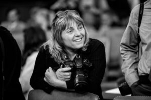 Susan Walsh holding a camera. Photo Provided.