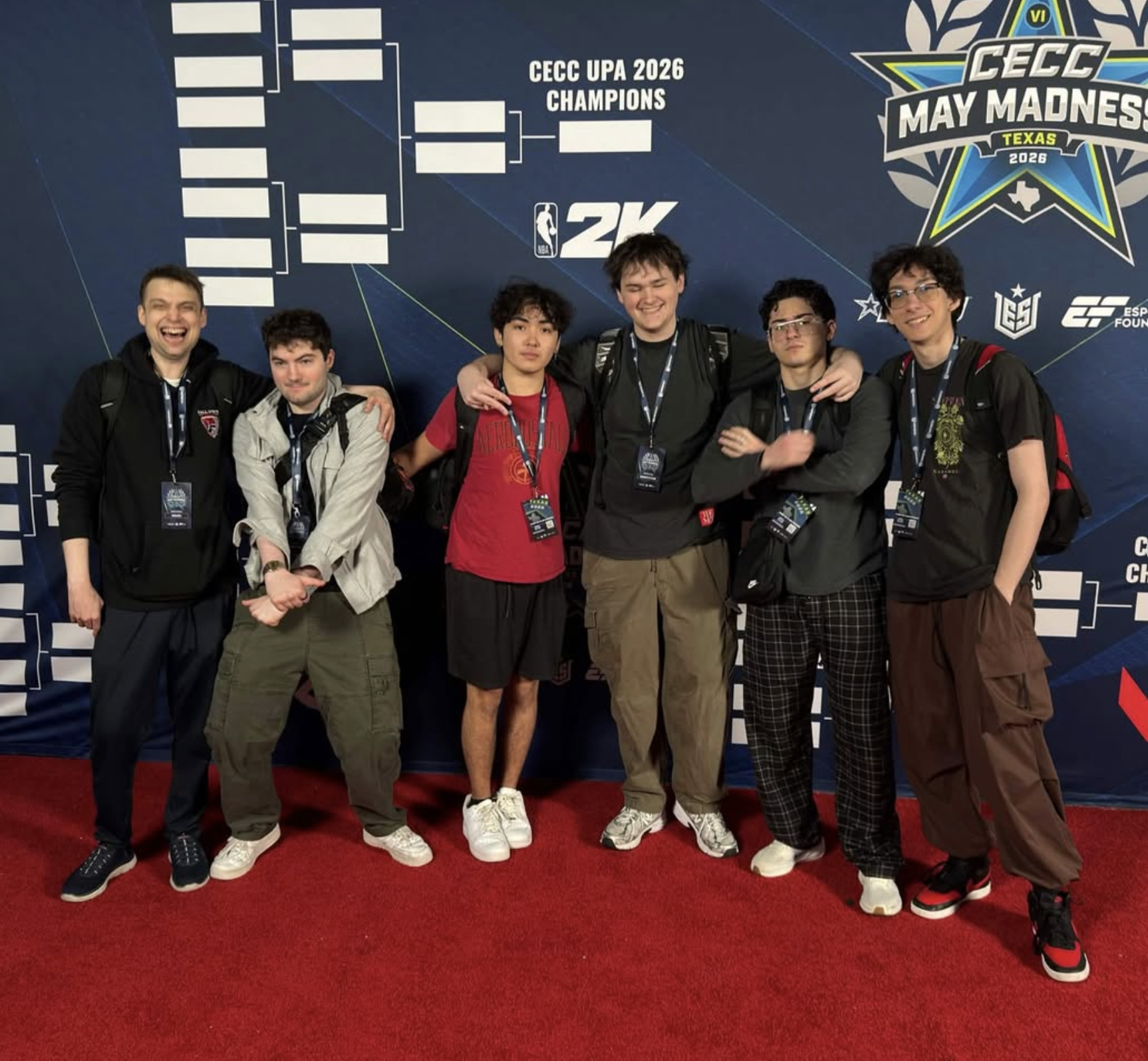 Six young men pose together on a red carpet in front of a tournament bracket backdrop for the CECC May Madness 2026 Texas esports event, smiling and with arms around each other's shoulders.