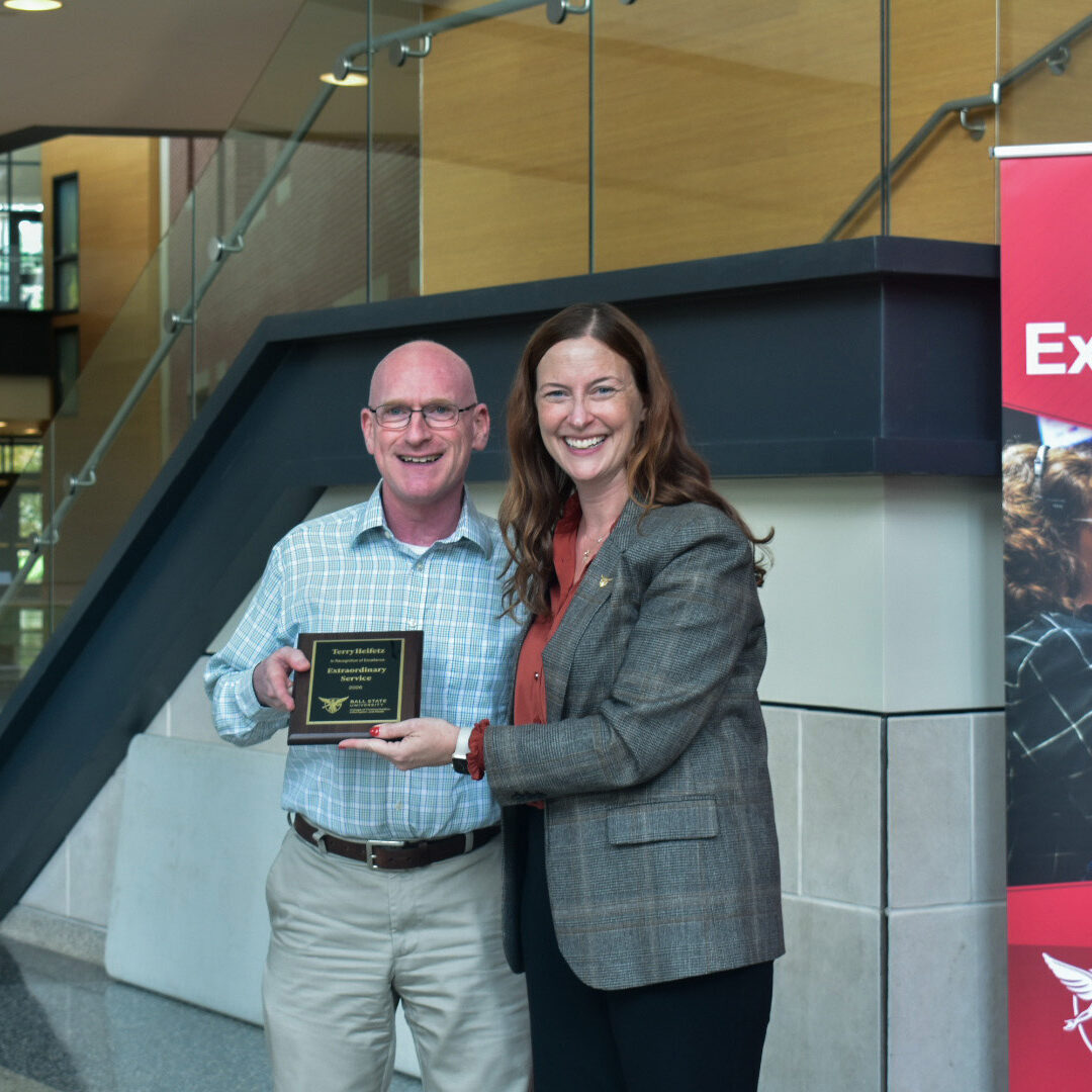 Dean McCauliff poses with Terry Heifetz for the CCIM Extraordinary Service award at the 2026 CCIM Faculty Awards Ceremony.