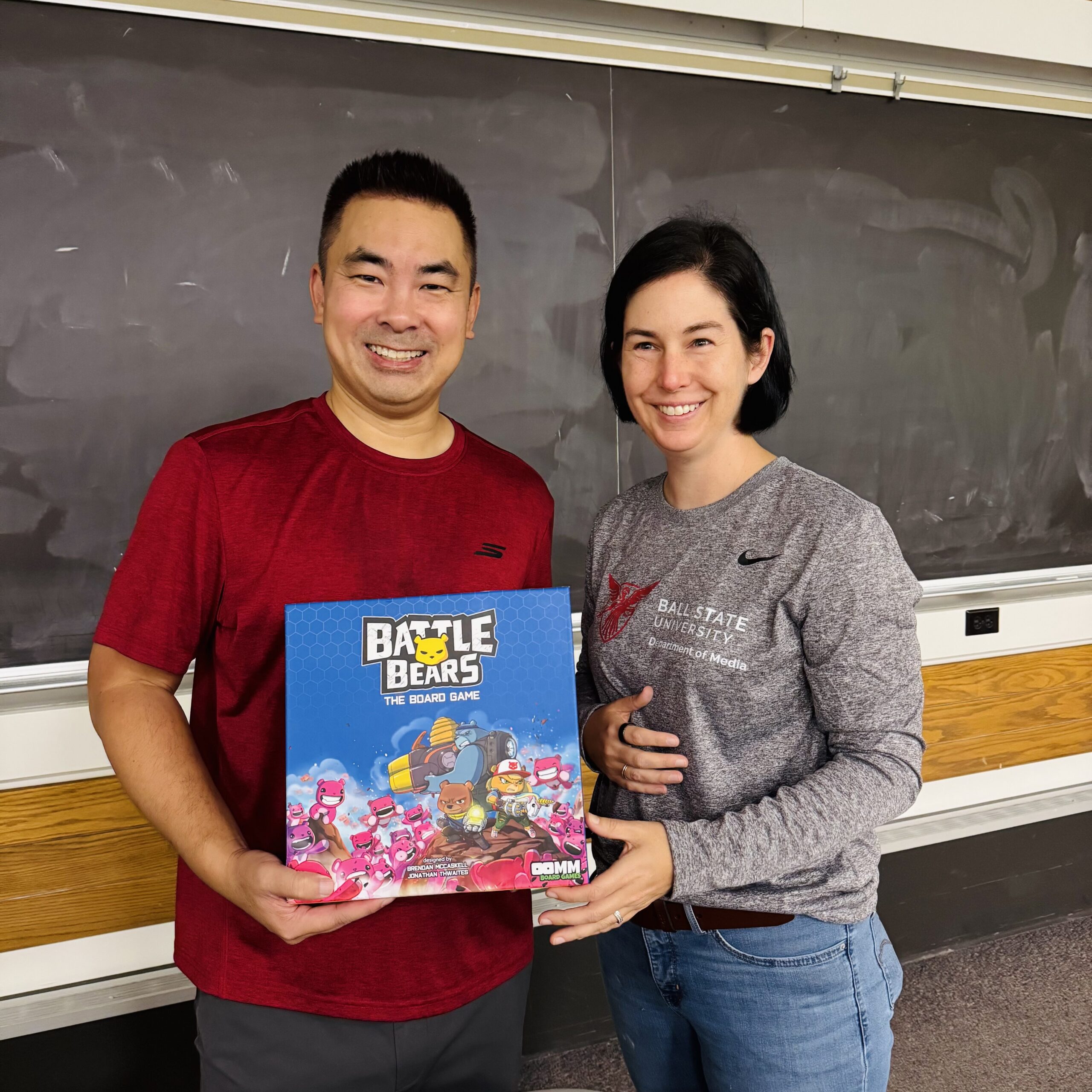 Ben Vu and Betsy Pike from Ball State's Department of Media pose with a Battle Bears board game.
