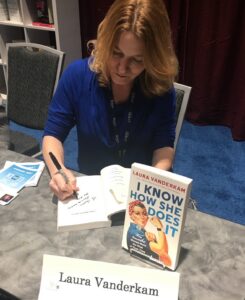Luara signing autographs of her book, "I know How She Does It."