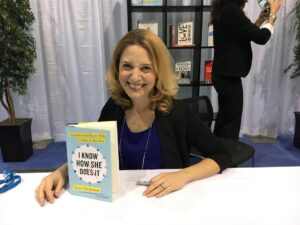 Laura Vanderkam posing with her book, "I Know How She Does It."