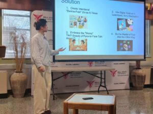 girl gesturing to a PowerPoint presentation