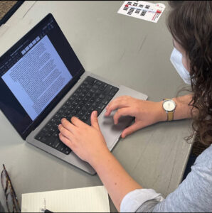 Writer types on a keyboard.