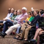 Audience members (including our Alumni Award winner Mary Jo Day and family) listen intently during the award ceremony