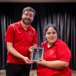 Student Sam Gomez and Ethan Hines (AD Disability Services) pose for a photo with the Kraska Award plaque