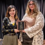 Student Dakota Esen and Mac Cook (AD Disability Services) pose for a photo with the Fehribach Award plaque