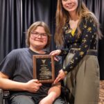 Student Joel Gernand and Mac Cook (AD Disability Services) pose for a photo with the Fehribach Award plaque