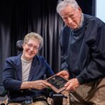 Richard Harris (Director Emeritus of Disability Services) and Mary Jo Day pose with the Harris-Rose Outstanding Alumnus Award plaque that Mary Jo was awarded