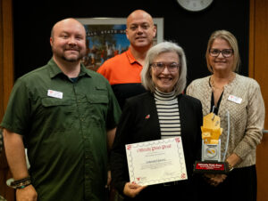 Ball State University Library Services accepting their Phishing Award 