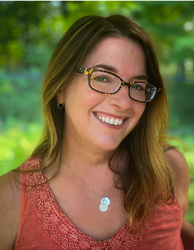 A woman with brown hair and glasses