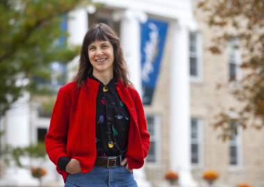 a woman with brown hair and a red sweater