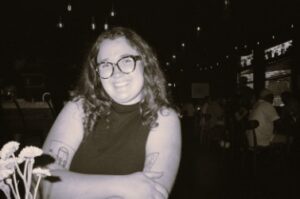 young woman with brown hair and glasses 