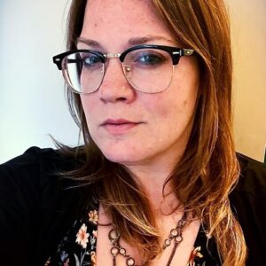 young woman with brown hair and glasses